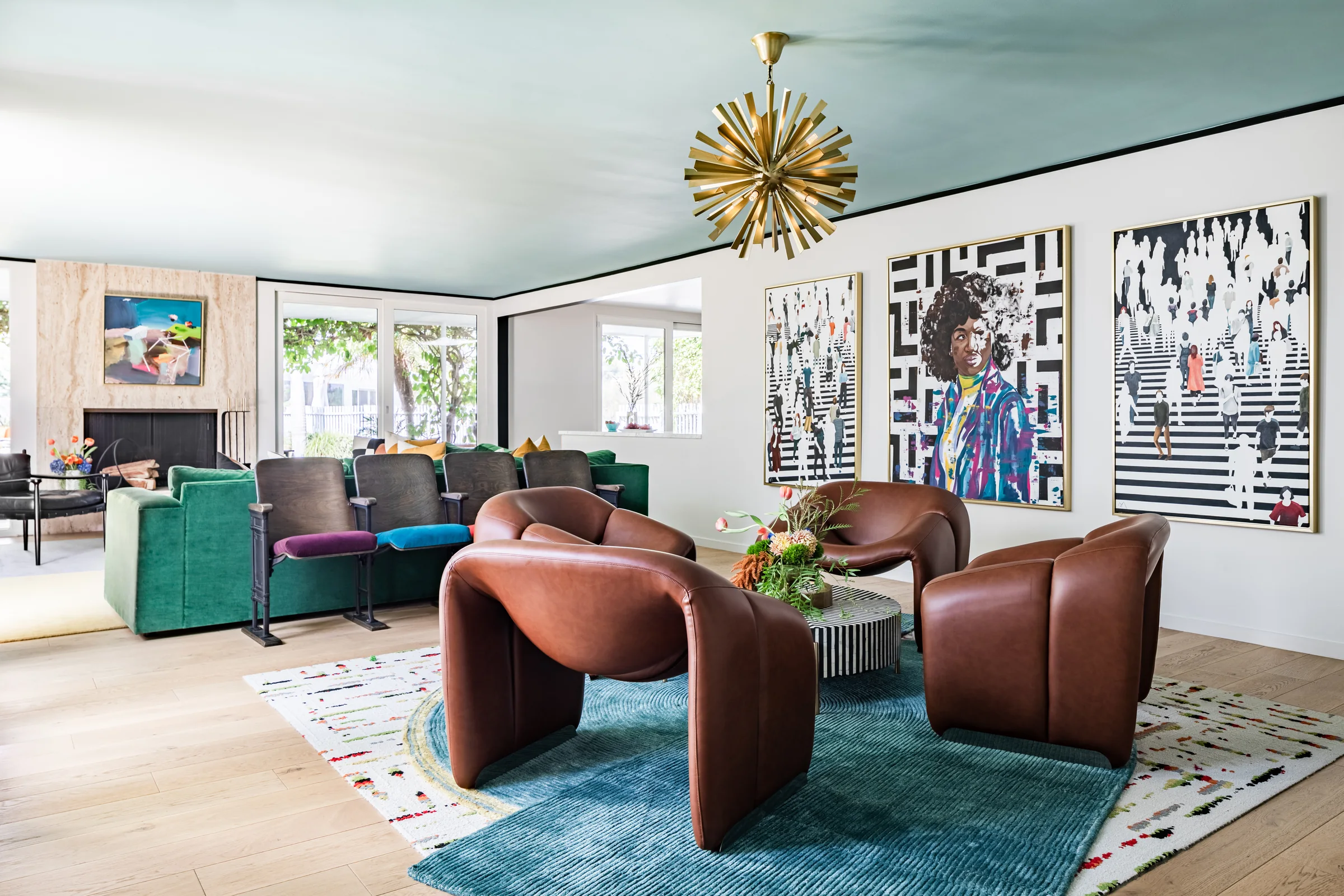 The full family room: sputnik chandelier, gallery wall and a wall of windows
