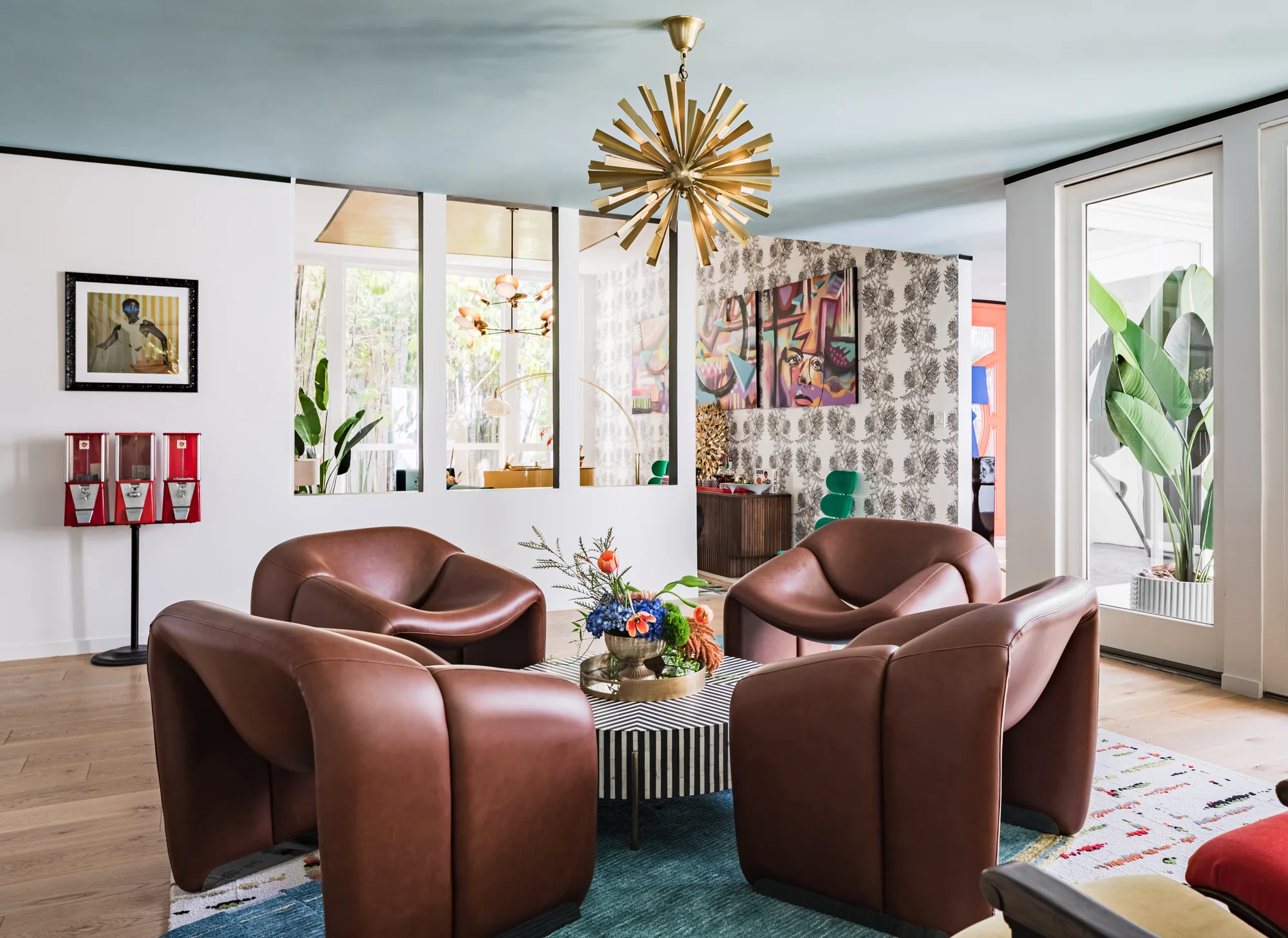Sculptural leather armchairs gathered on a blue rug