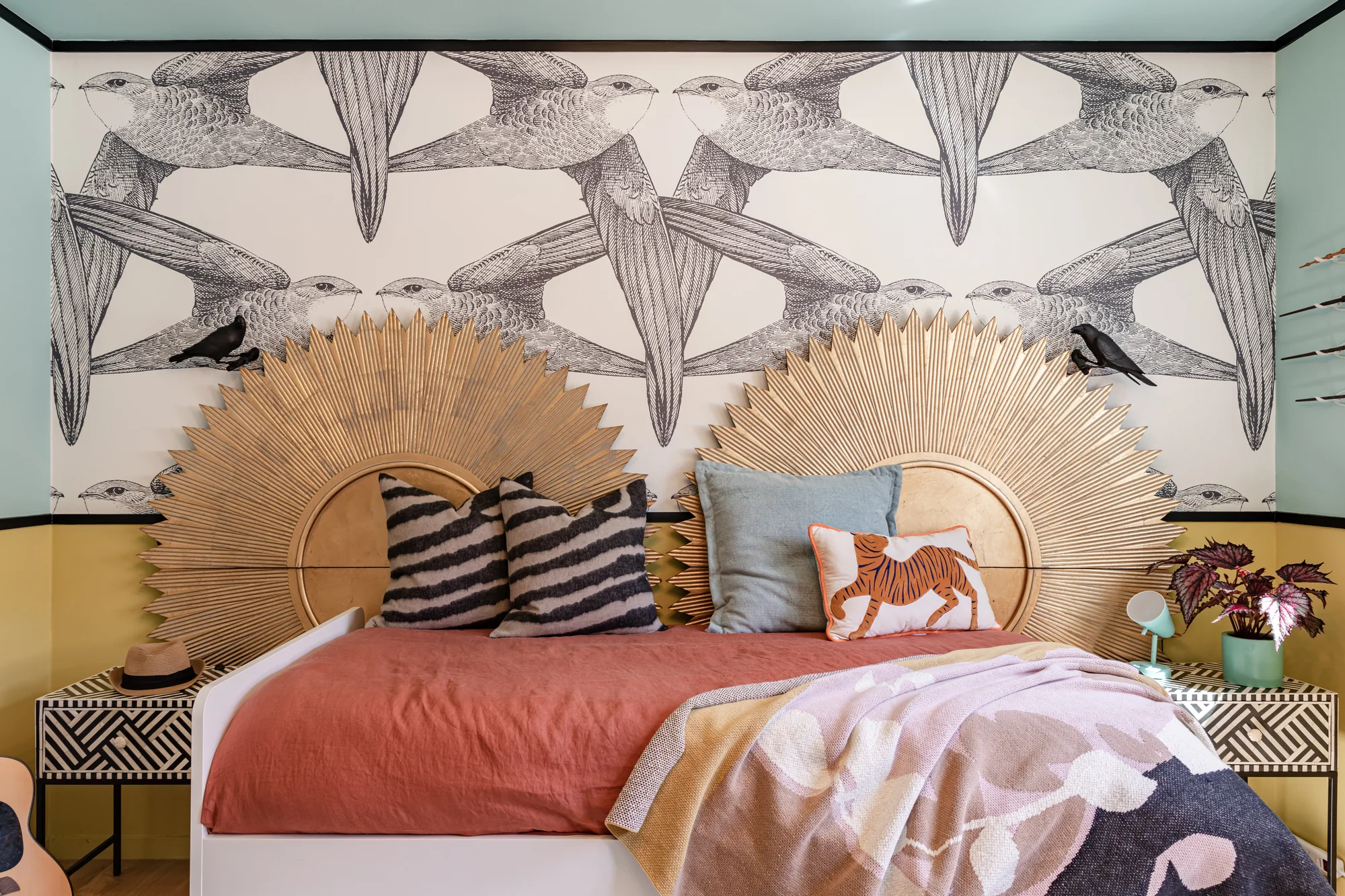 Girls bedroom under a hand-drawn bird wallcovering
