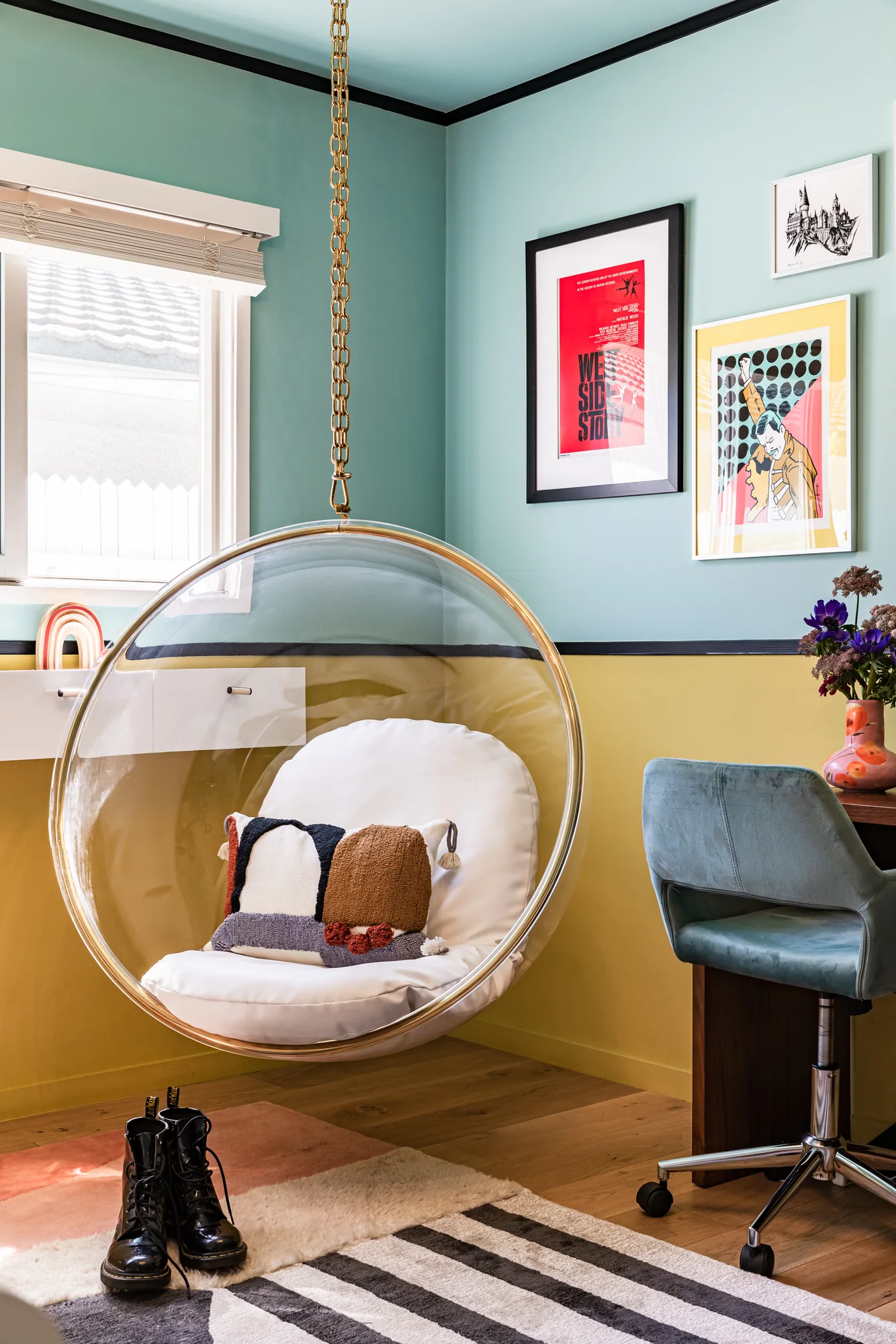 Hanging bubble chair in a yellow and teal bedroom