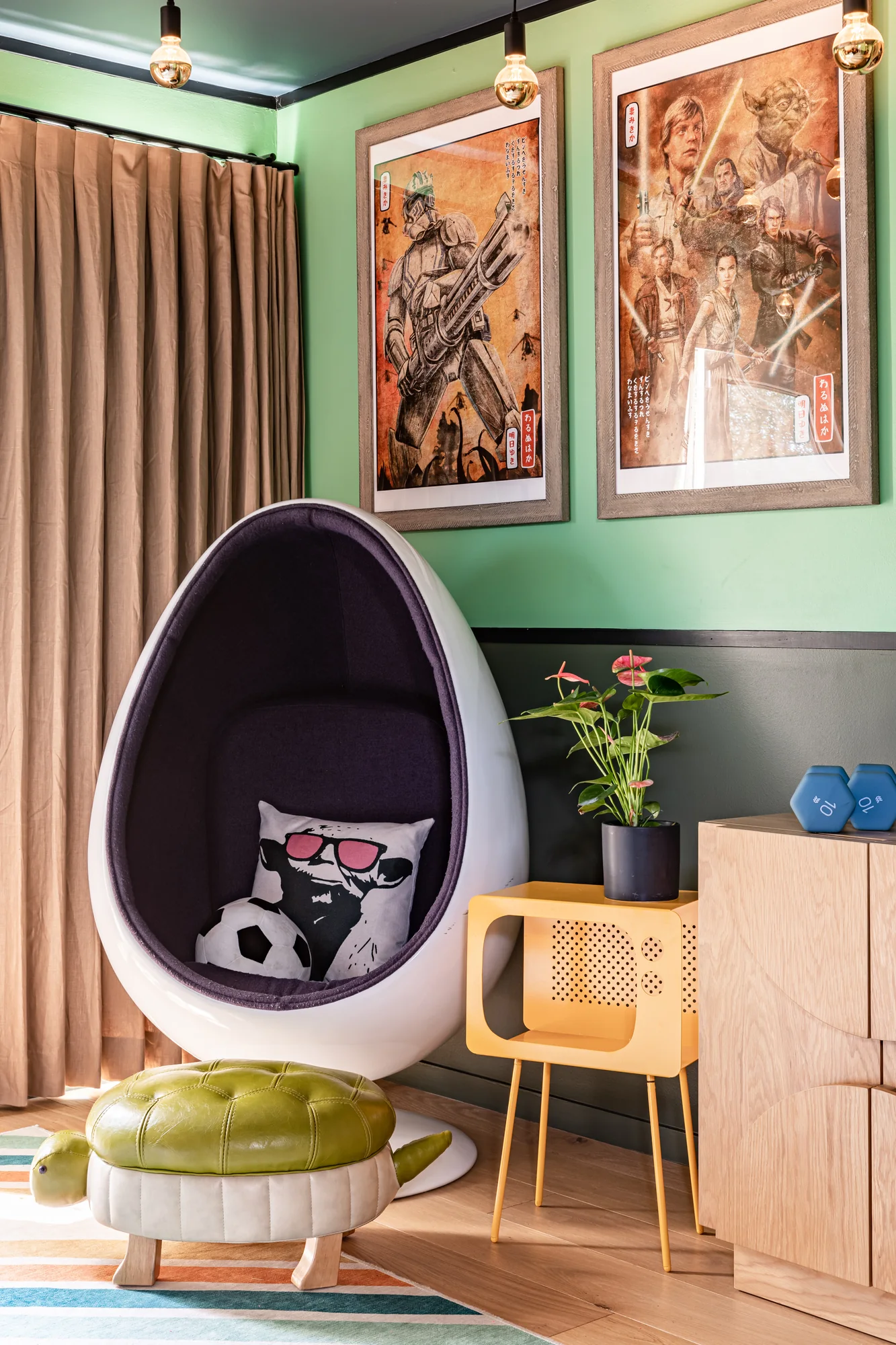 Boy's room with green walls, comic-book art and a purple egg chair