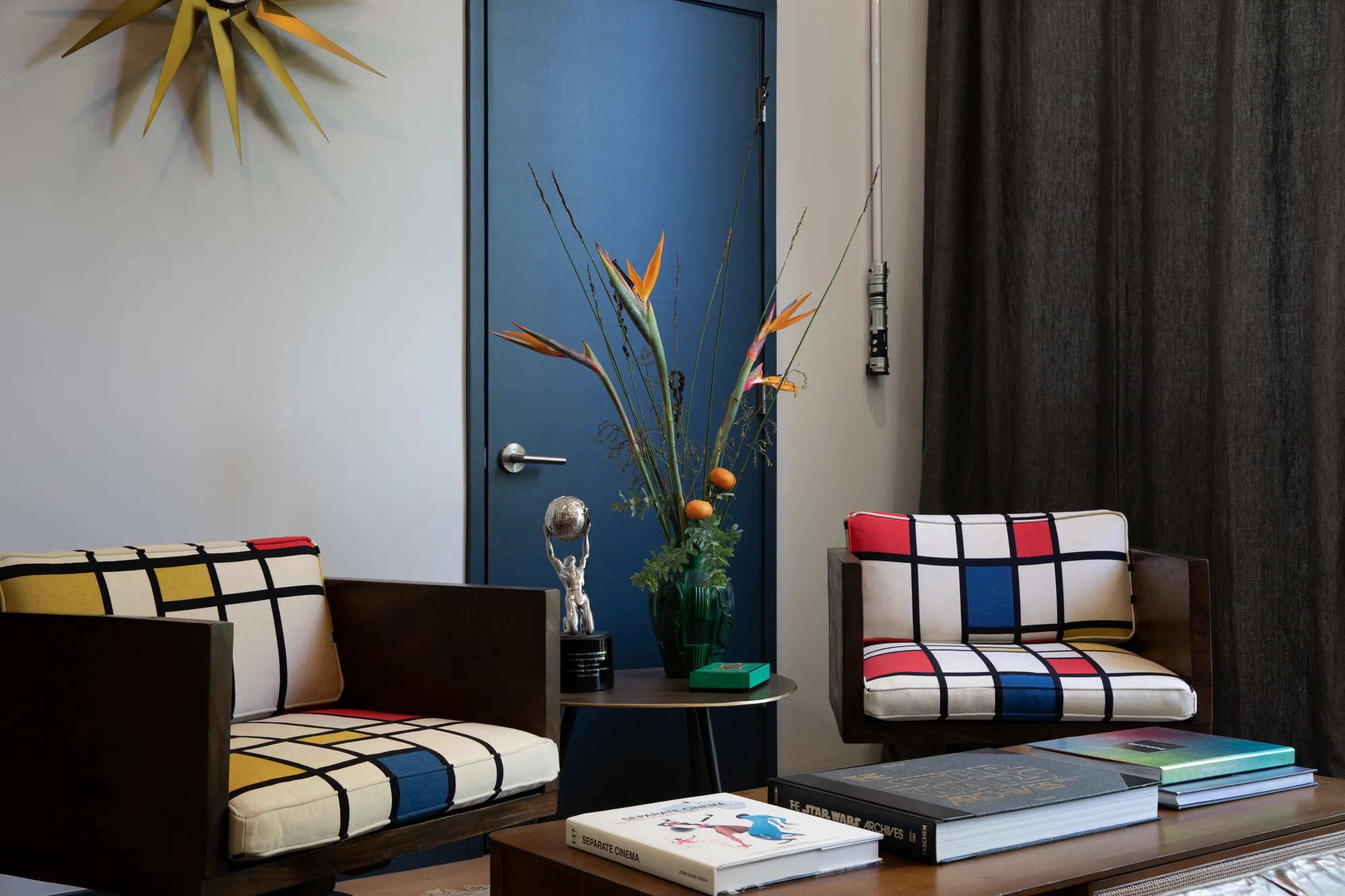 Office with Mondrian-print armchairs and a blue door