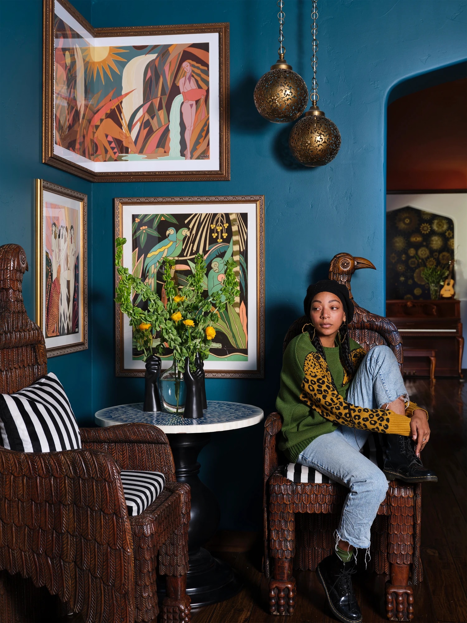 Carmen René Smith seated in the teal corner nook beside a bistro table of lemons