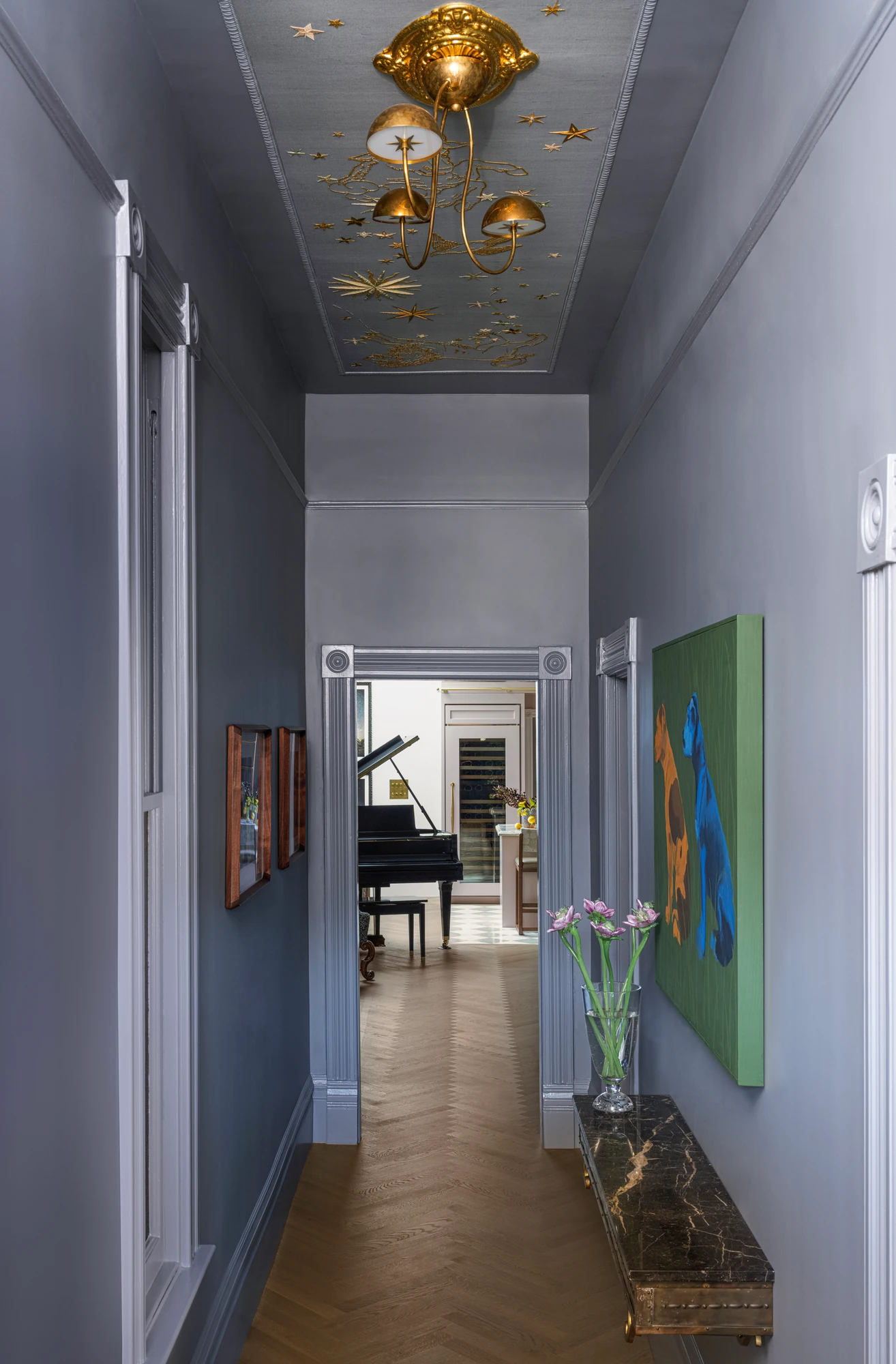Hallway beneath a gilded star ceiling, looking through to the music room