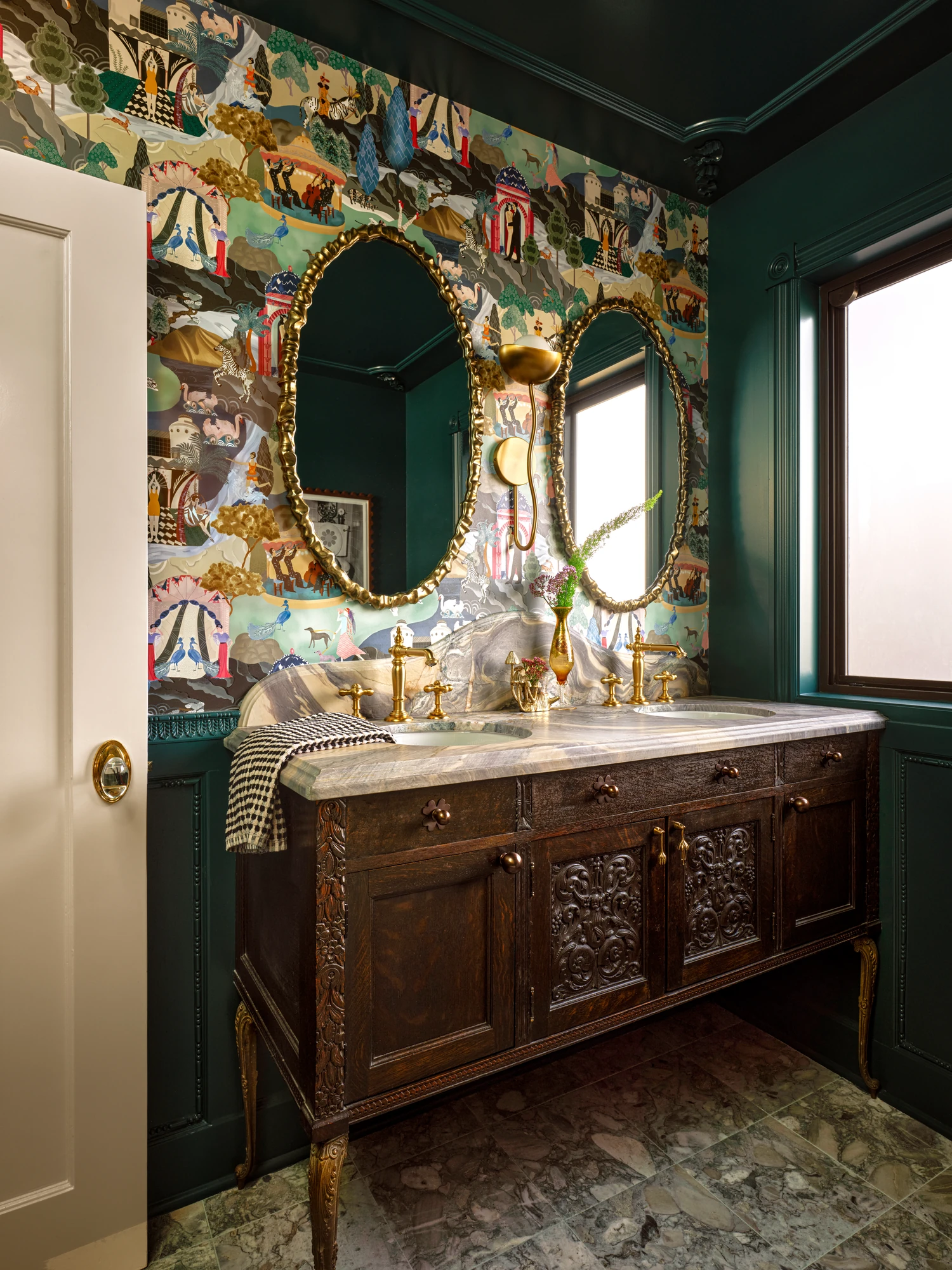Powder room in de Gournay wallpaper with an antique cabinet turned vanity