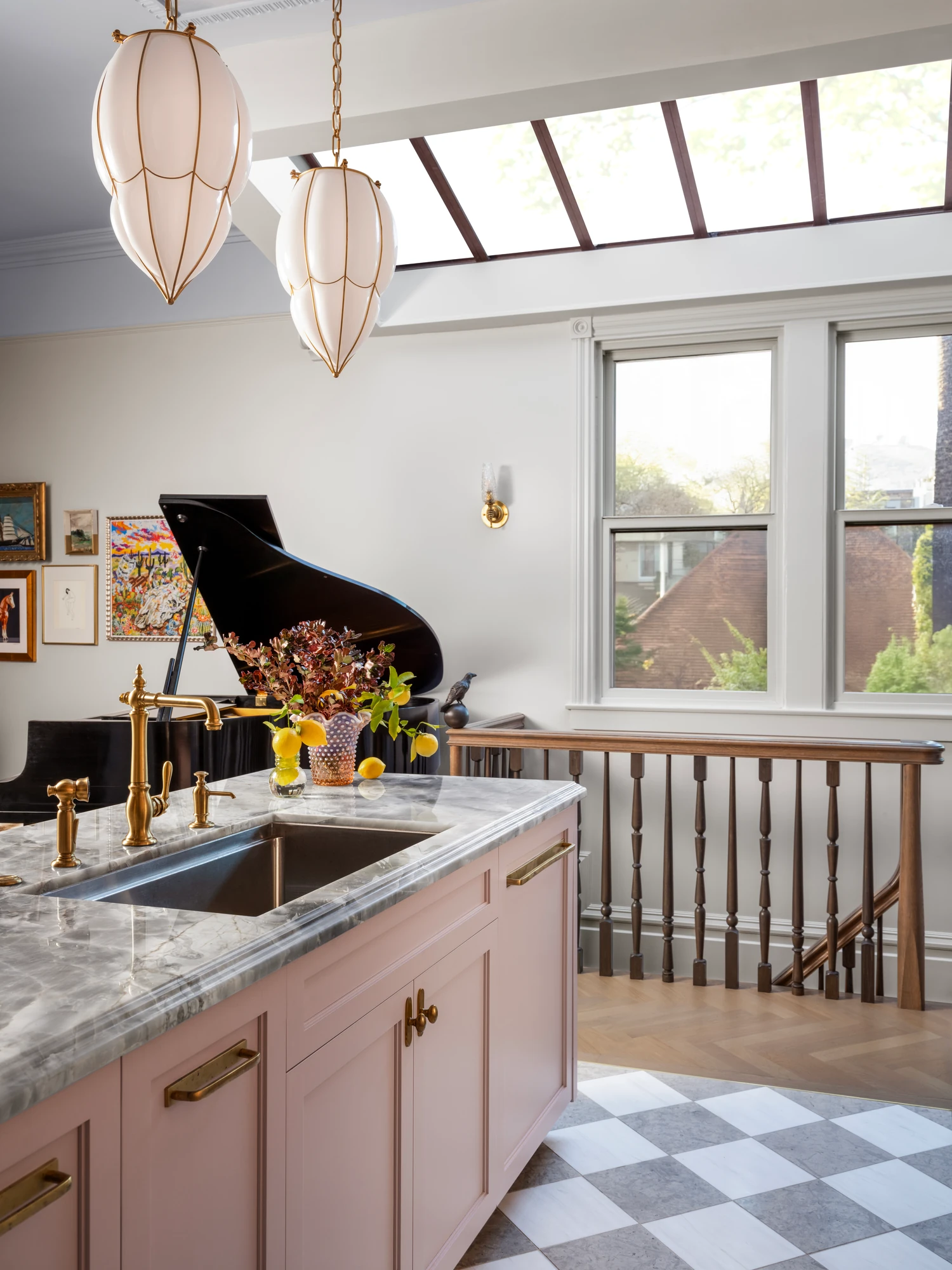 Marble island and pendant lights under the skylight, looking to the stair