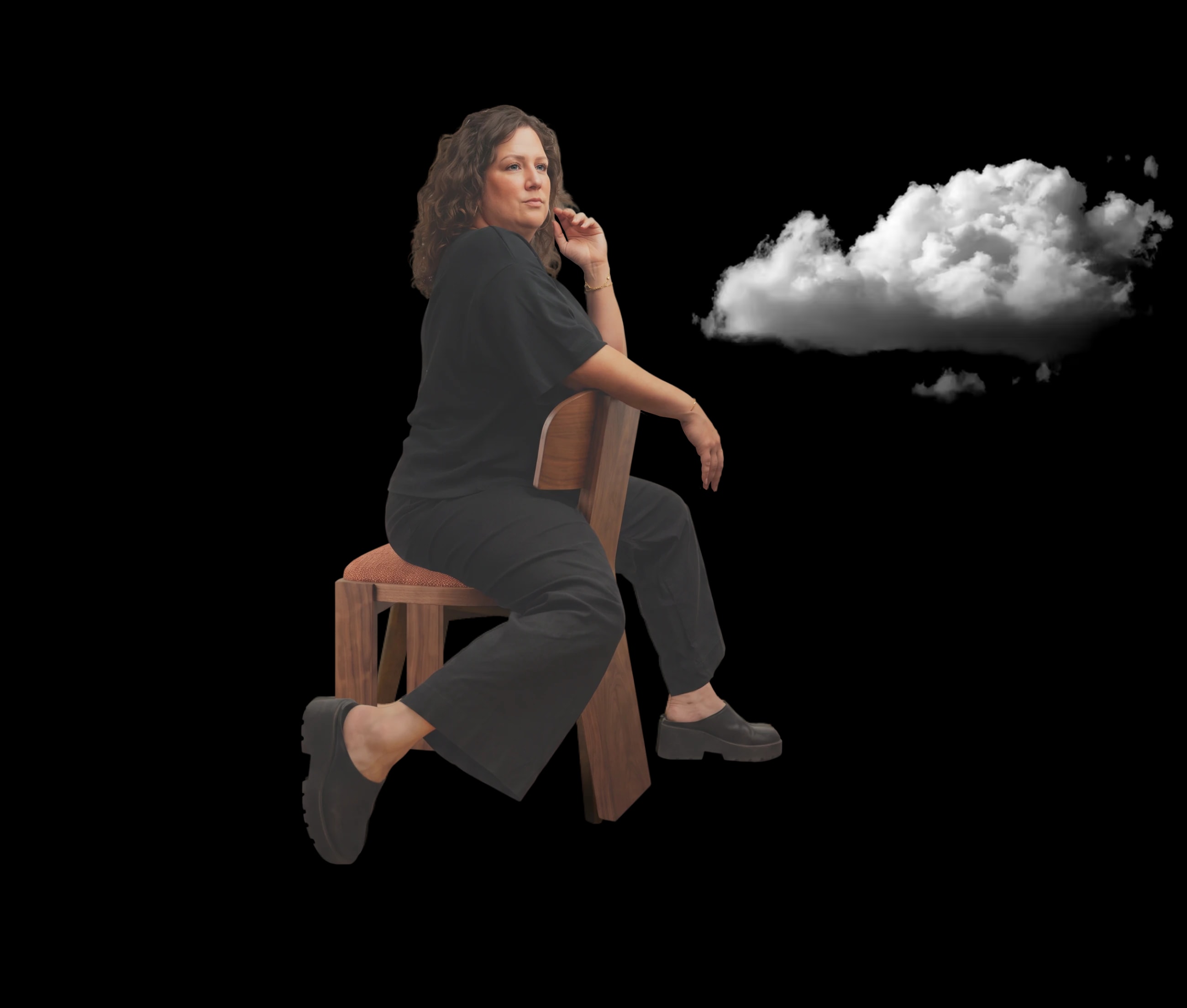 Micha Keyser seated on a wooden chair