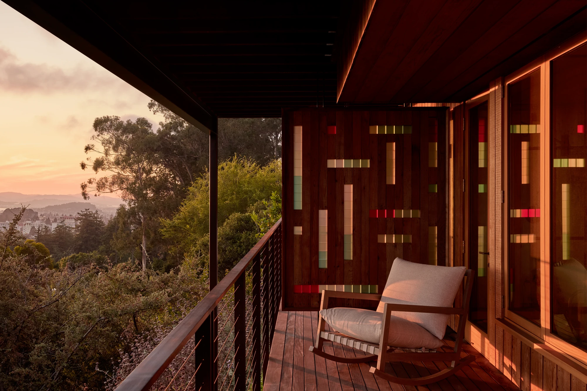 Covered deck at sunset with a rocking chair over the valley