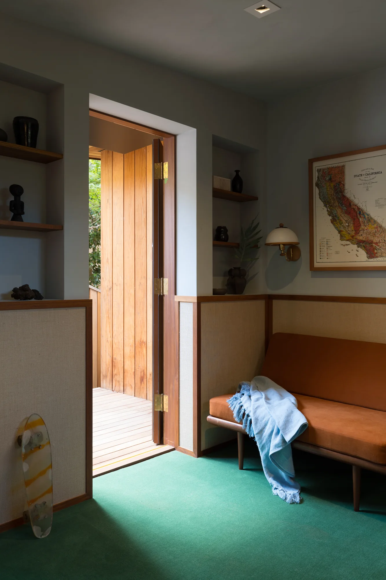 Doorway onto a green-carpeted room with a built-in bench