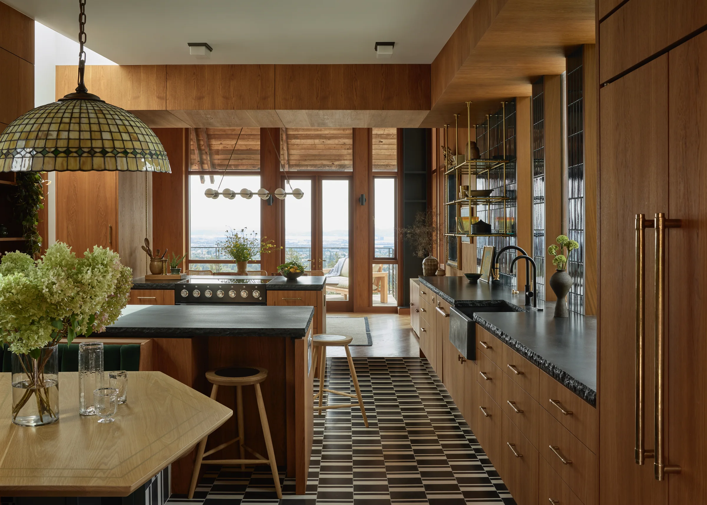 The long kitchen down its checkerboard floor to the bay view