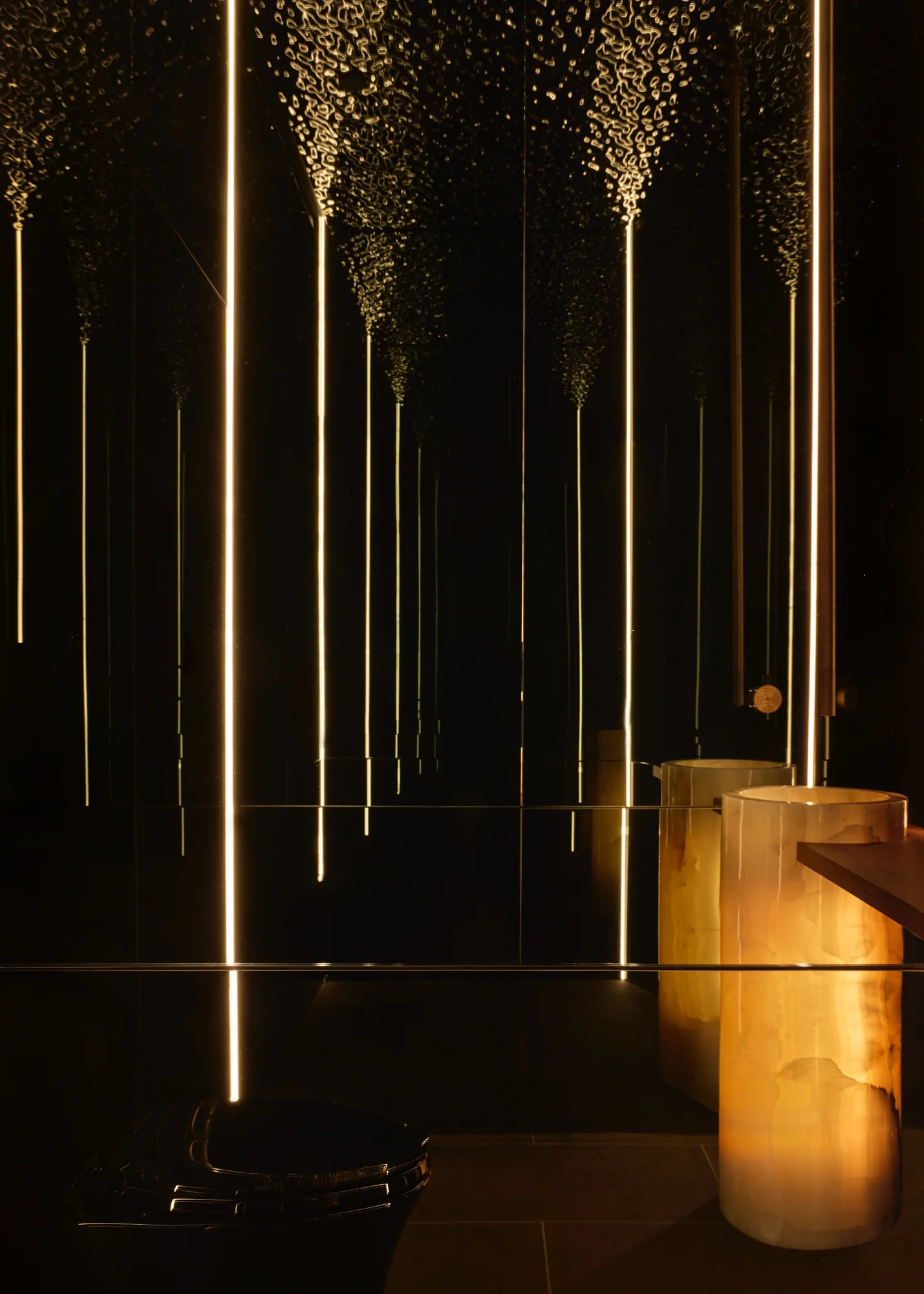 The powder room in black mirror, onyx and ripple glass