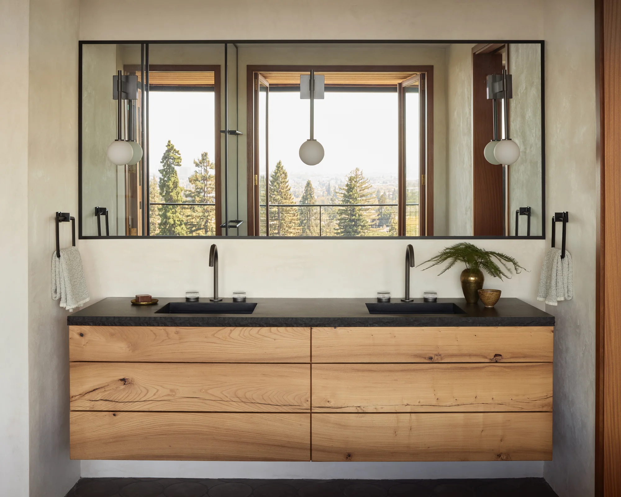 Primary bathroom double vanity under a run of windows